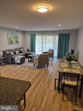 a living room with furniture window and wooden floor