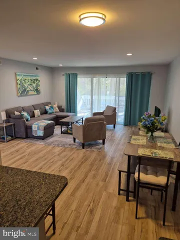 a living room with furniture window and wooden floor