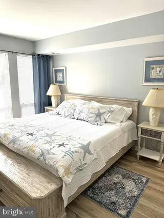 a large bed sitting in a bedroom next to a window