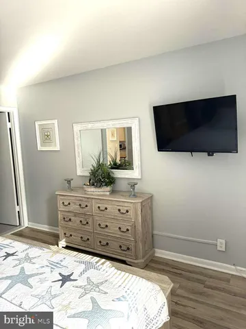 a room with a bed a television and a window