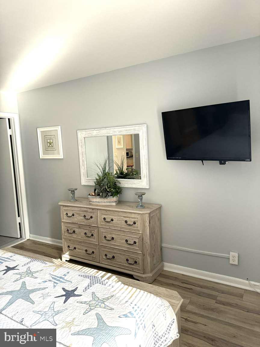 39633 Round Robin Way, Unit 2602 Bethany Beach, DE 19930 - Photo 15 of 43 a room with a bed a television and a window