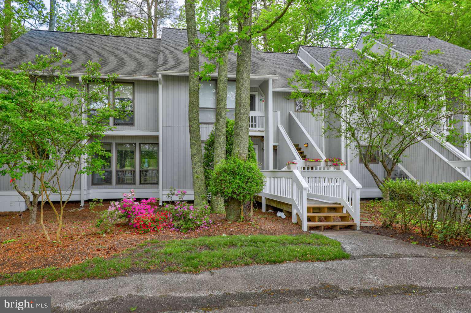 39633 Round Robin Way, Unit 2602 Bethany Beach, DE 19930 - Photo 27 of 43 a front view of house with a yard and potted plants