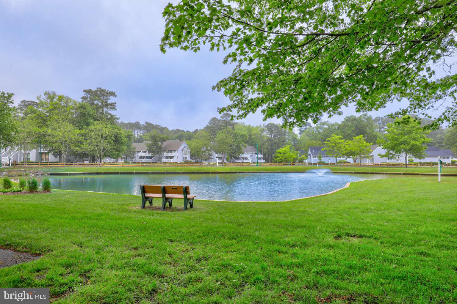 39633 Round Robin Way, Unit 2602 Bethany Beach, DE 19930 - Photo 29 of 43 a view of outdoor space with swimming pool and green space