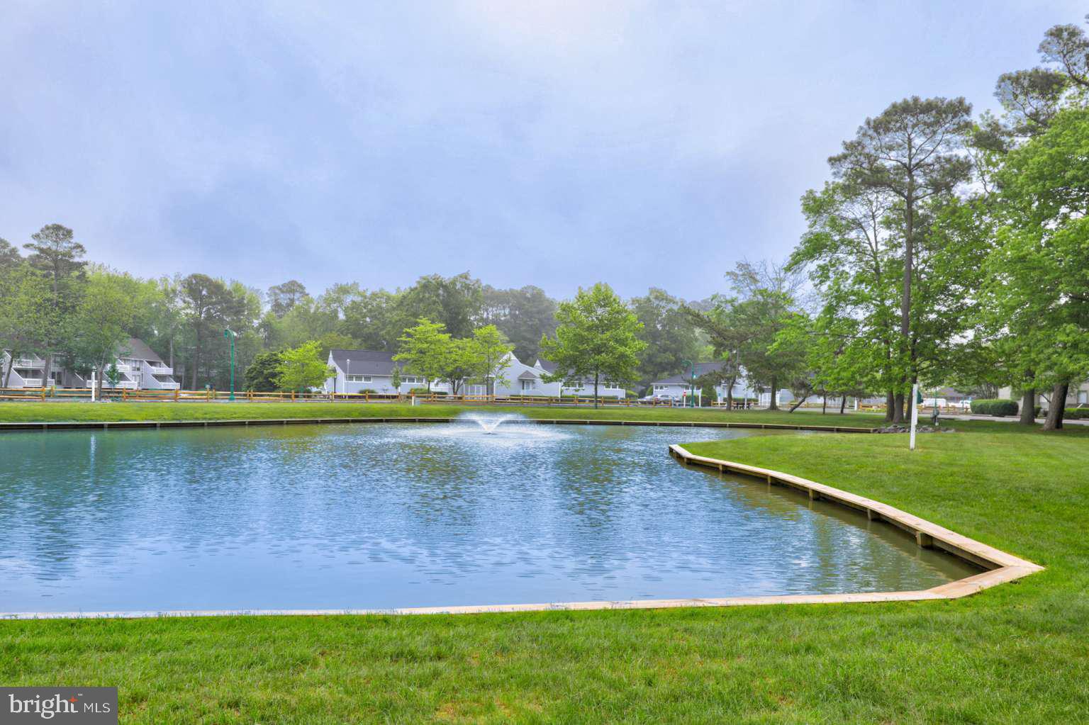 39633 Round Robin Way, Unit 2602 Bethany Beach, DE 19930 - Photo 32 of 43 a view of a lake with houses in the background
