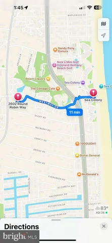 a view of a street with a bench and trees