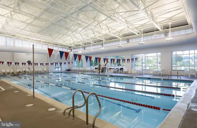 a view of a chair and table in backyard of the house