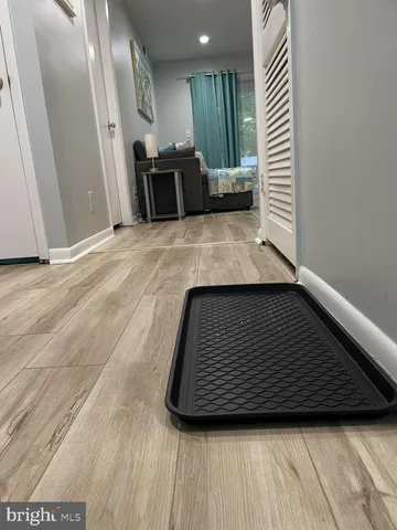 a view of a hallway with wooden floor