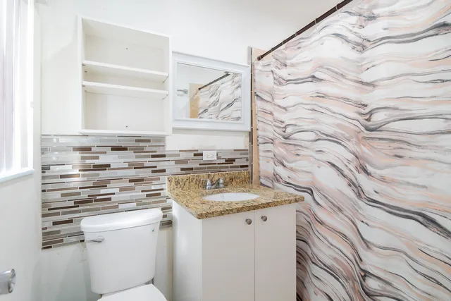 a kitchen that has a sink and a stove in it