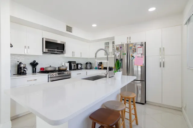 a kitchen with a sink and a refrigerator