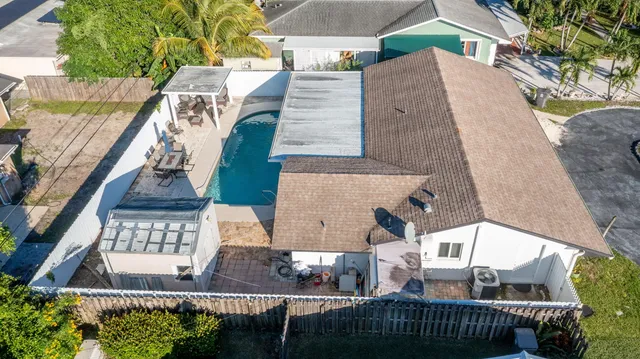 an aerial view of a house with a swimming pool