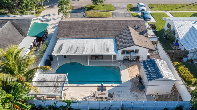 an aerial view of a swimming pool and outdoor seating