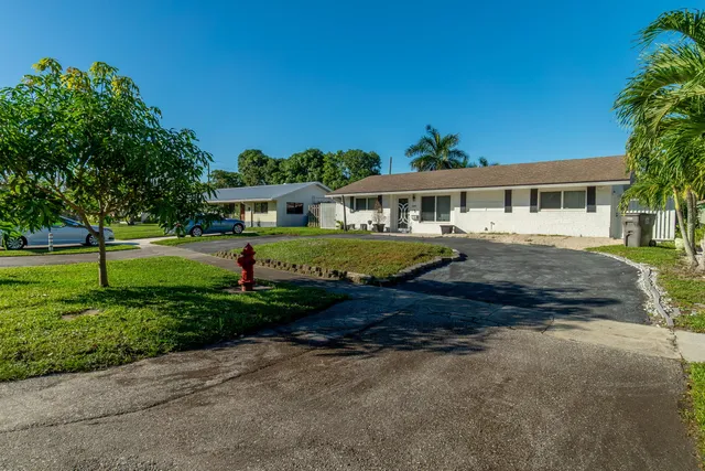 a project room with furniture and a dining table with kitchen view