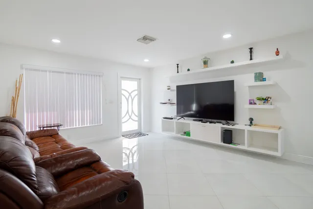 a living room with a couch and a window