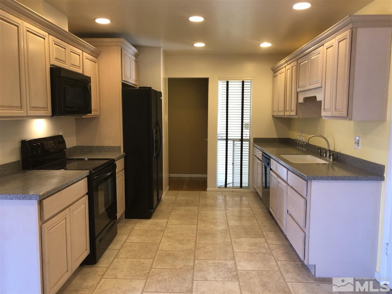 695 Ibis Lane Reno, NV 89503 - Photo 3 of 14 a kitchen with stainless steel appliances granite countertop a refrigerator and a stove top oven
