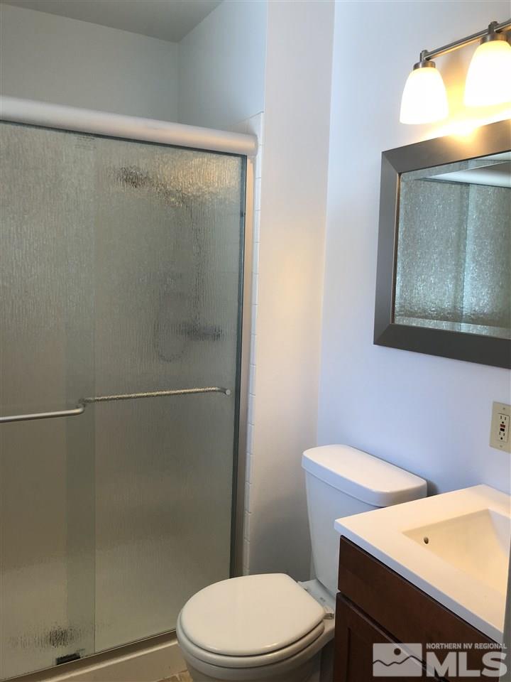 695 Ibis Lane Reno, NV 89503 - Photo 6 of 14 a white toilet sitting next to a bathroom sink