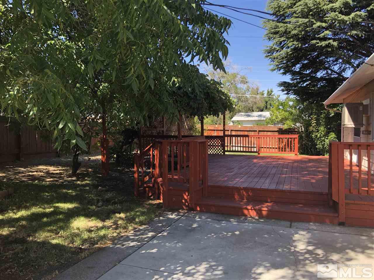 695 Ibis Lane Reno, NV 89503 - Photo 10 of 14 a view of a wooden house with a large tree