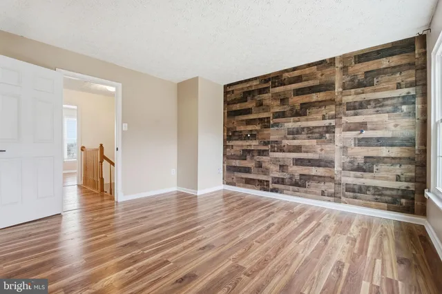 wooden floor in an empty room with a fireplace