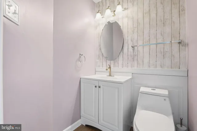 a bathroom with a toilet a sink and mirror