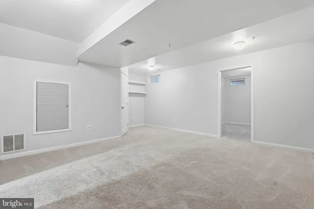 an empty room with windows and closet