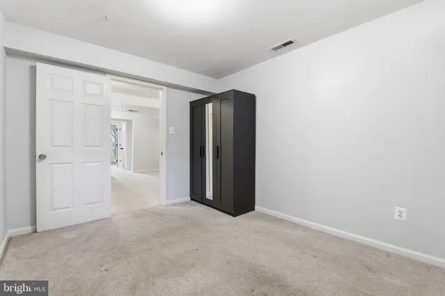 an empty room with closet area