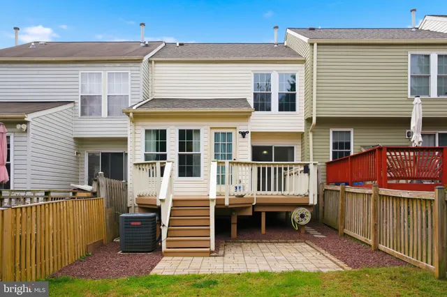 a view of a house with a yard and wooden fence