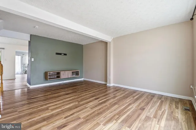 a view of a room with wooden floor and a fireplace