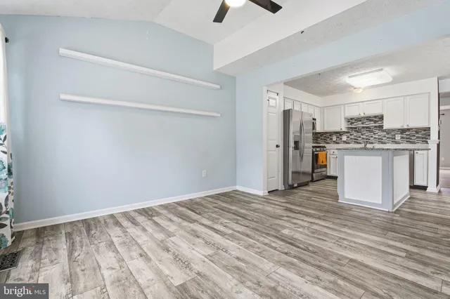 a view of a kitchen with a sink and refrigerator