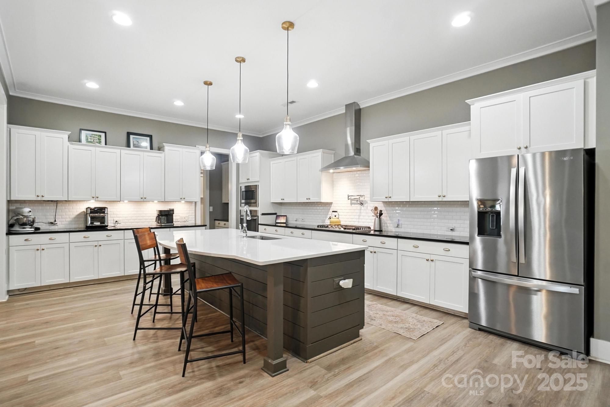 1908 Masons Bend Drive Fort Mill, SC 29708 - Photo 11 of 45 a kitchen with stainless steel appliances granite countertop a table chairs stove microwave and cabinets