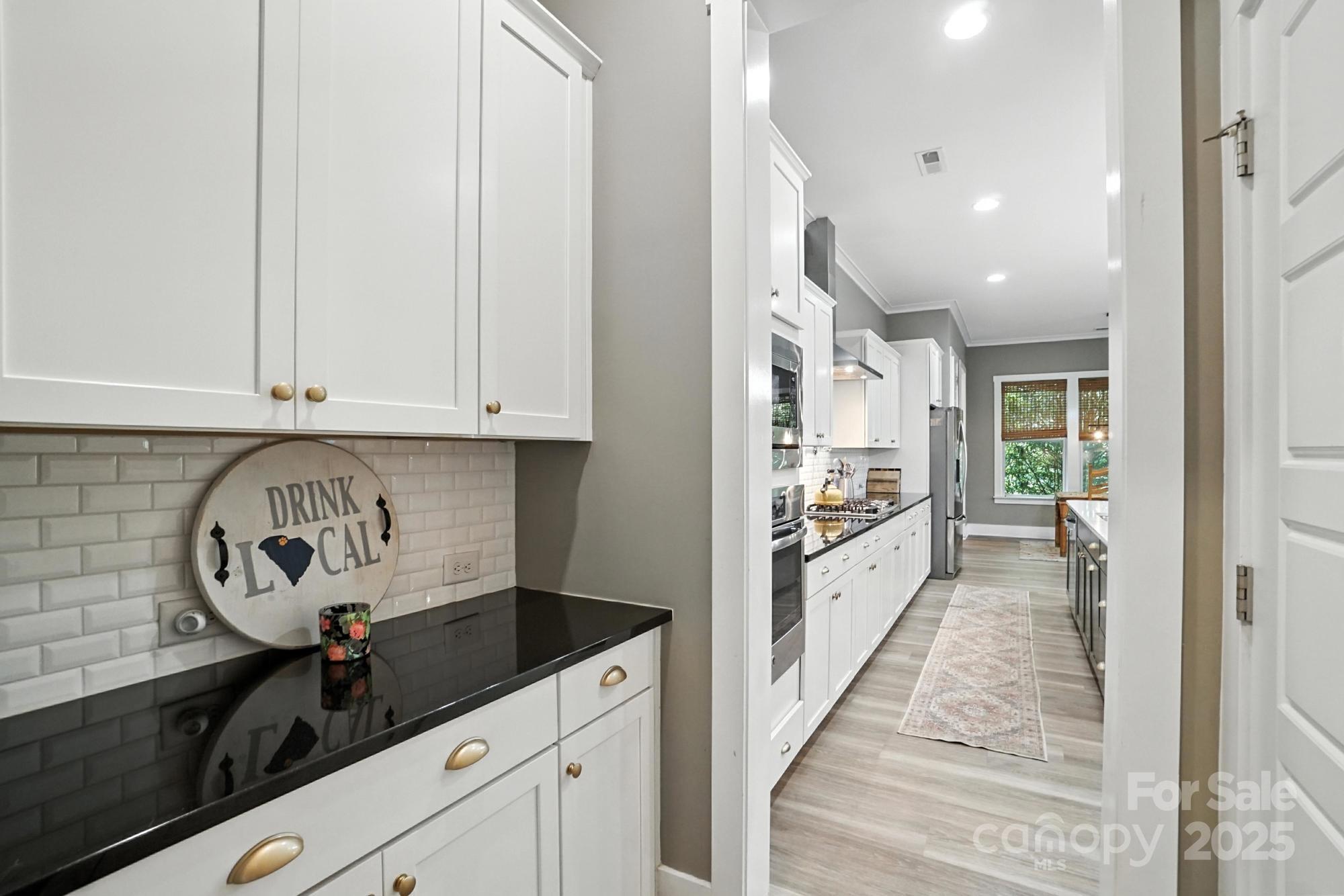 1908 Masons Bend Drive Fort Mill, SC 29708 - Photo 16 of 45 a large white kitchen with granite countertop a stove a sink and dishwasher