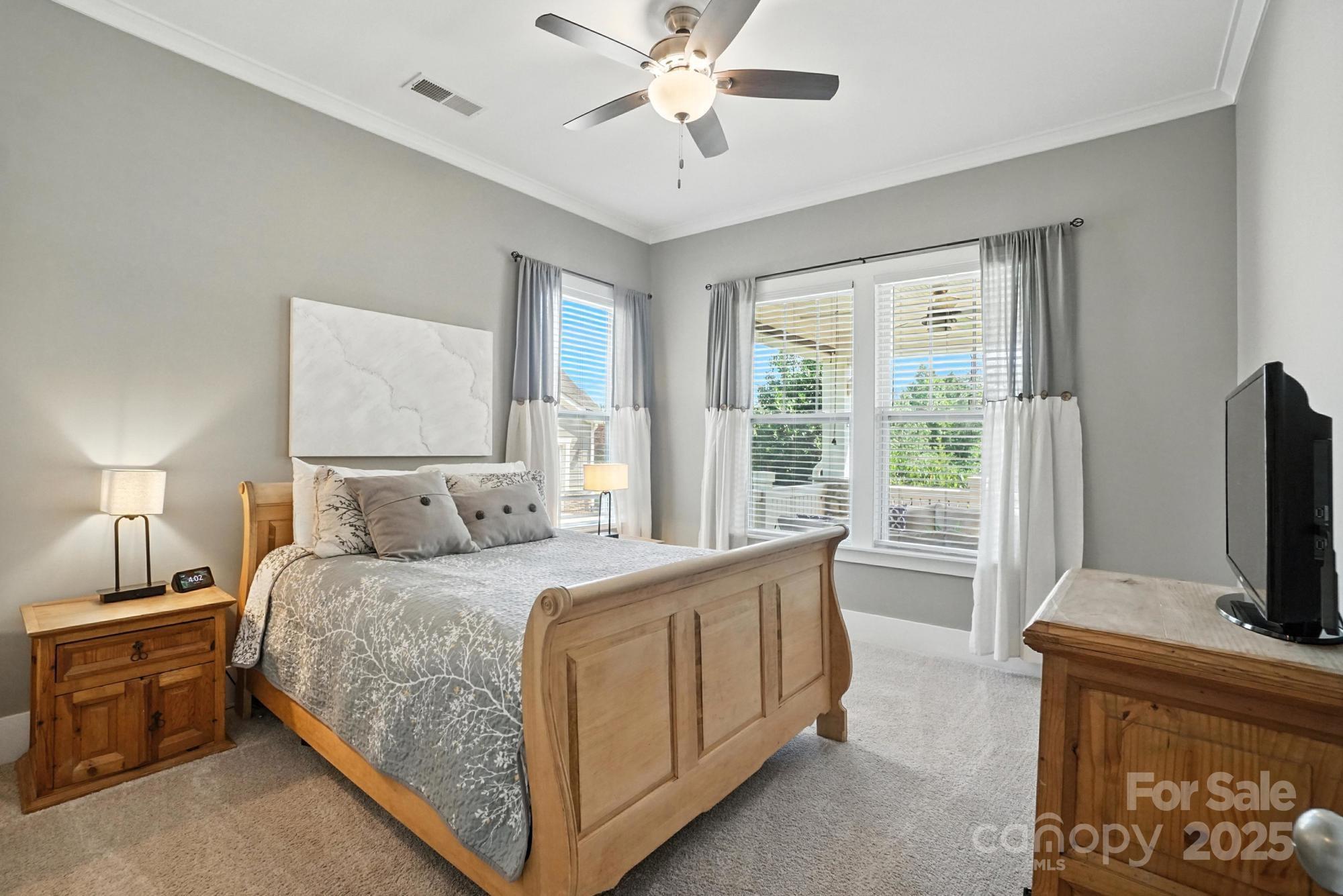 1908 Masons Bend Drive Fort Mill, SC 29708 - Photo 18 of 45 a bedroom with a bed flat screen tv and a chandelier