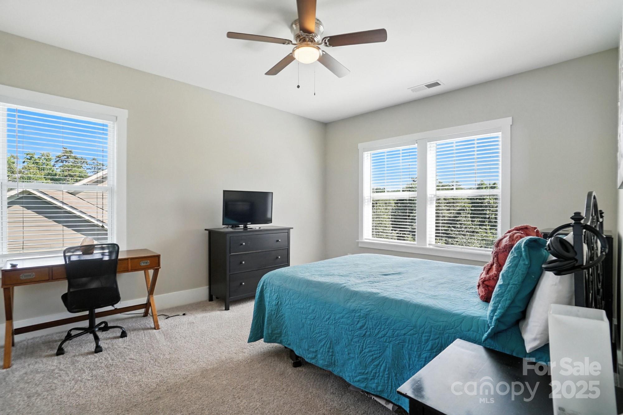 1908 Masons Bend Drive Fort Mill, SC 29708 - Photo 32 of 45 a bedroom with a bed a chair and a large window
