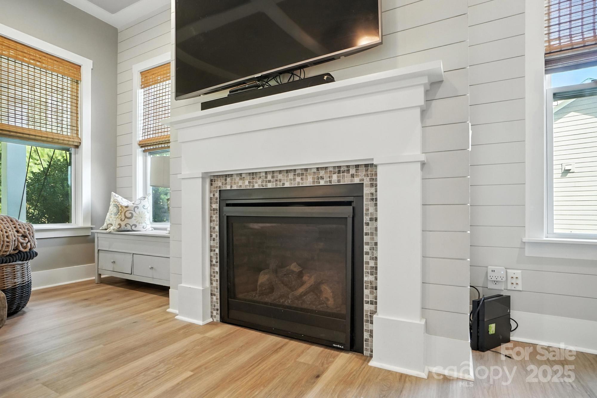 1908 Masons Bend Drive Fort Mill, SC 29708 - Photo 9 of 45 a living room with a fireplace wooden floor and windows