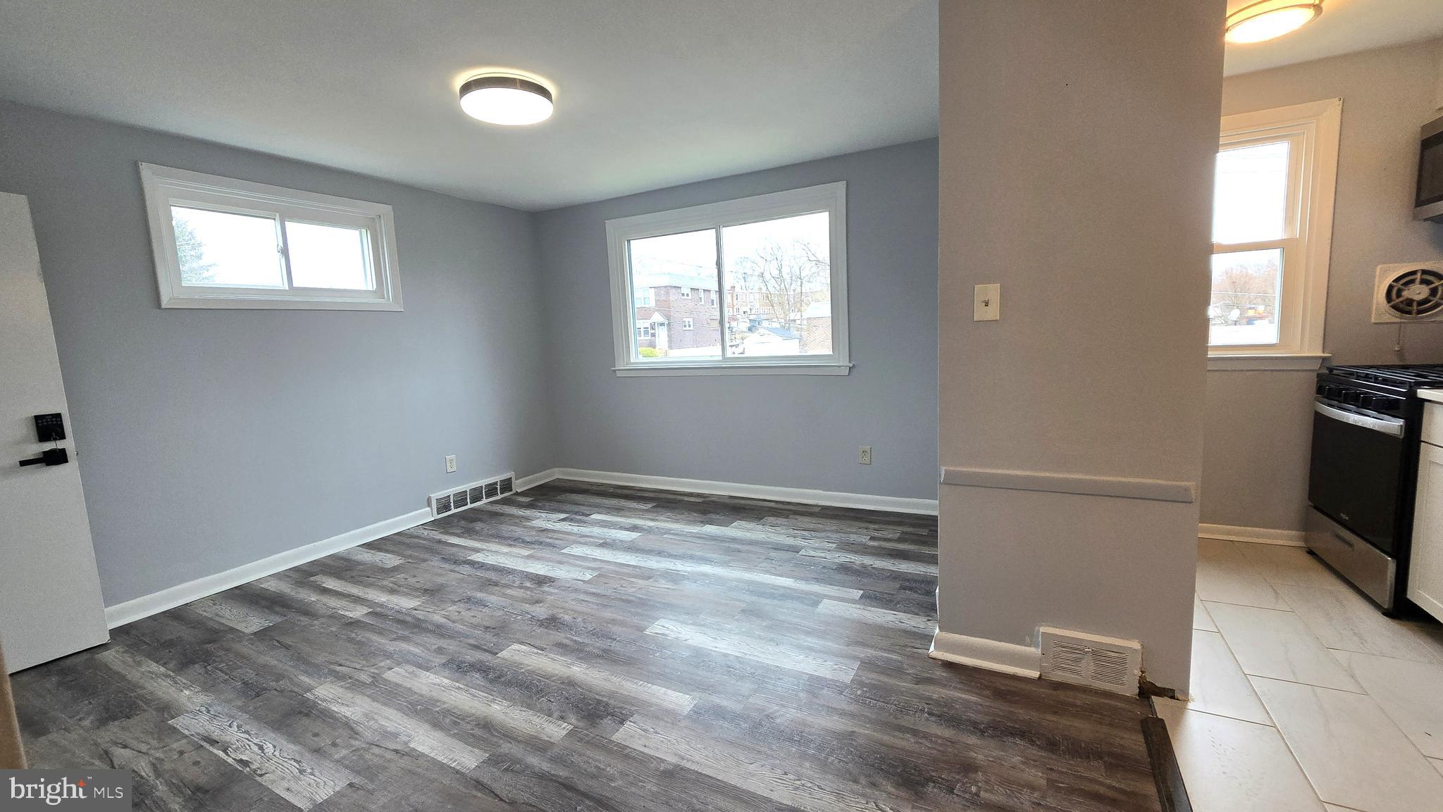 5099 Palmers Mill Road, Unit 2 Clifton Heights, PA 19018 - Photo 4 of 11 a view of empty room with window and wooden floor