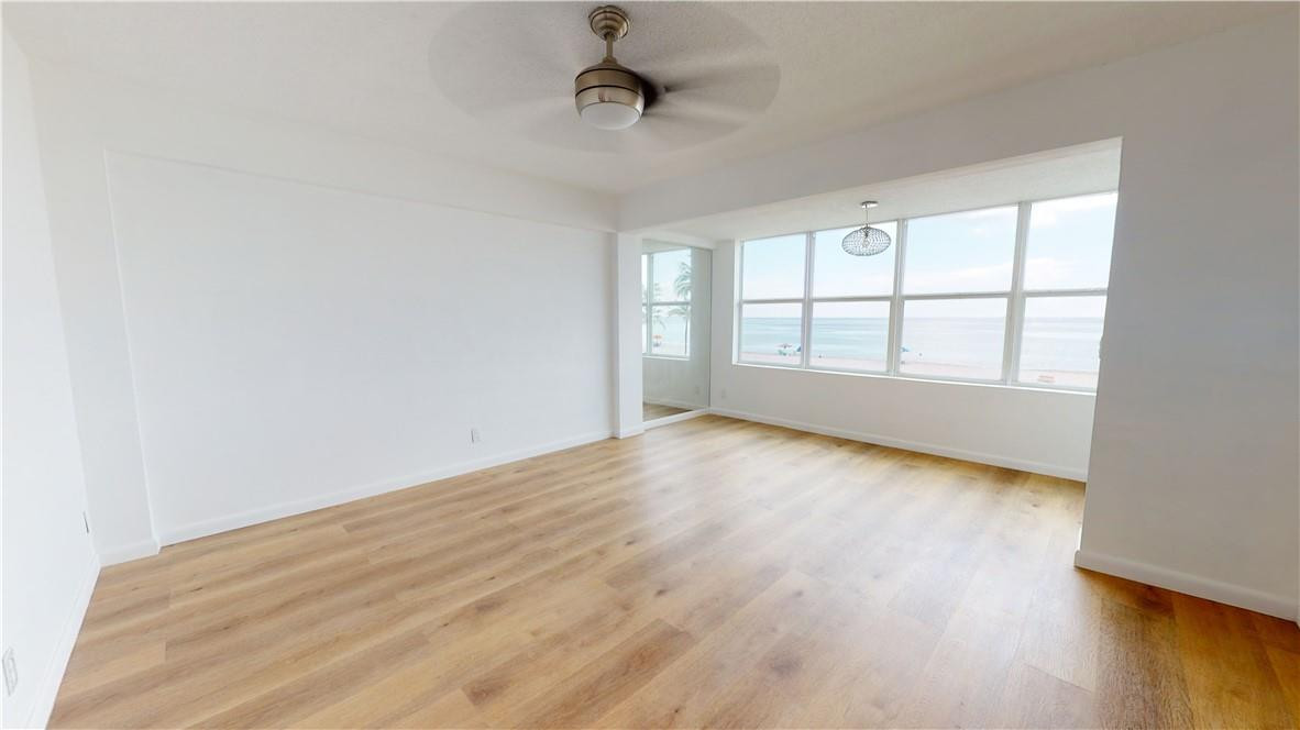 1801 South Surf Road, Unit 2F Hollywood, FL 33019 - Photo 11 of 22 an empty room with wooden floor and windows