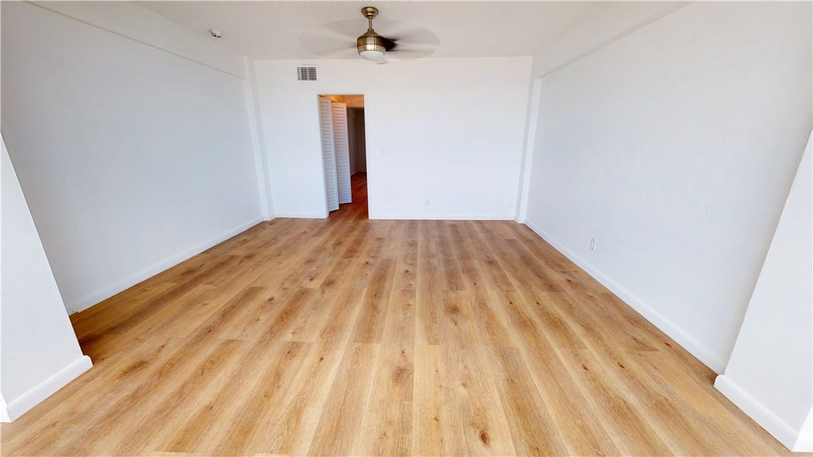 1801 South Surf Road, Unit 2F Hollywood, FL 33019 - Photo 13 of 22 a view of a room with wooden floor and a ceiling fan