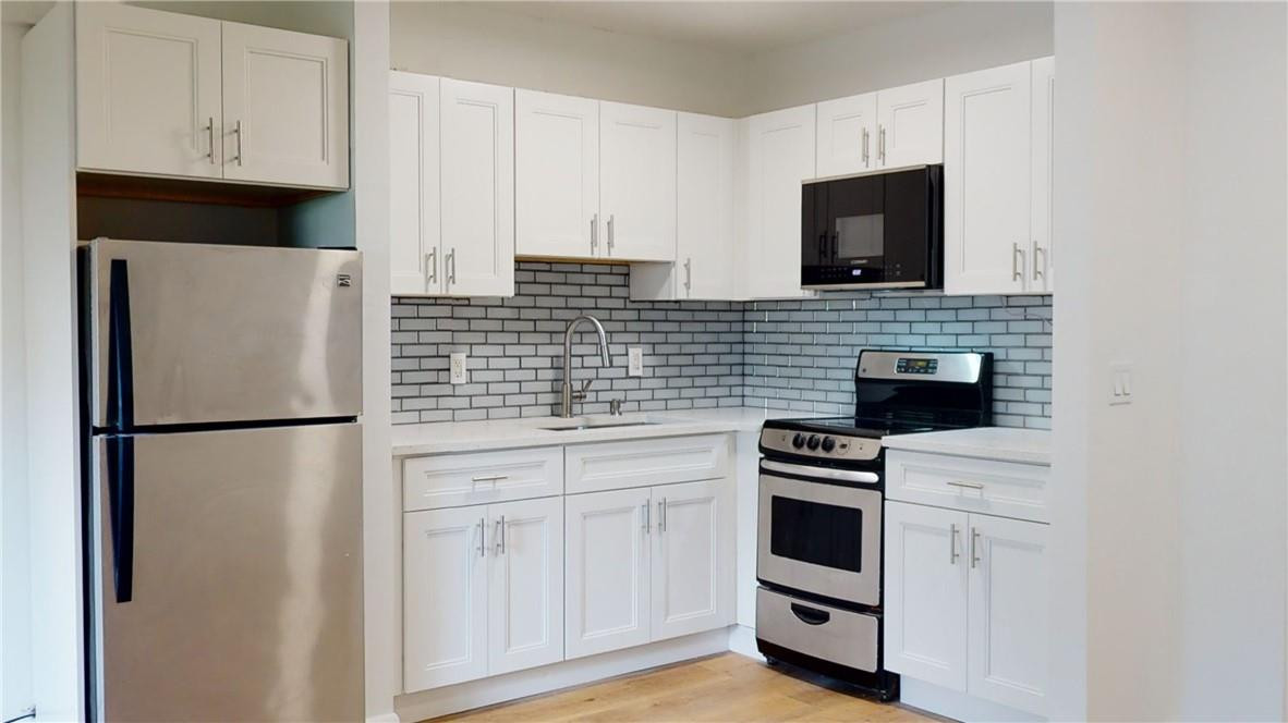 1801 South Surf Road, Unit 2F Hollywood, FL 33019 - Photo 3 of 22 a kitchen with white cabinets and white appliances