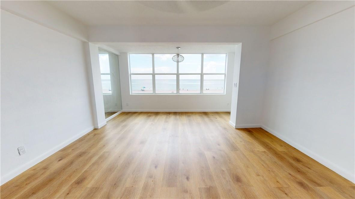 1801 South Surf Road, Unit 2F Hollywood, FL 33019 - Photo 4 of 22 an empty room with wooden floor and windows