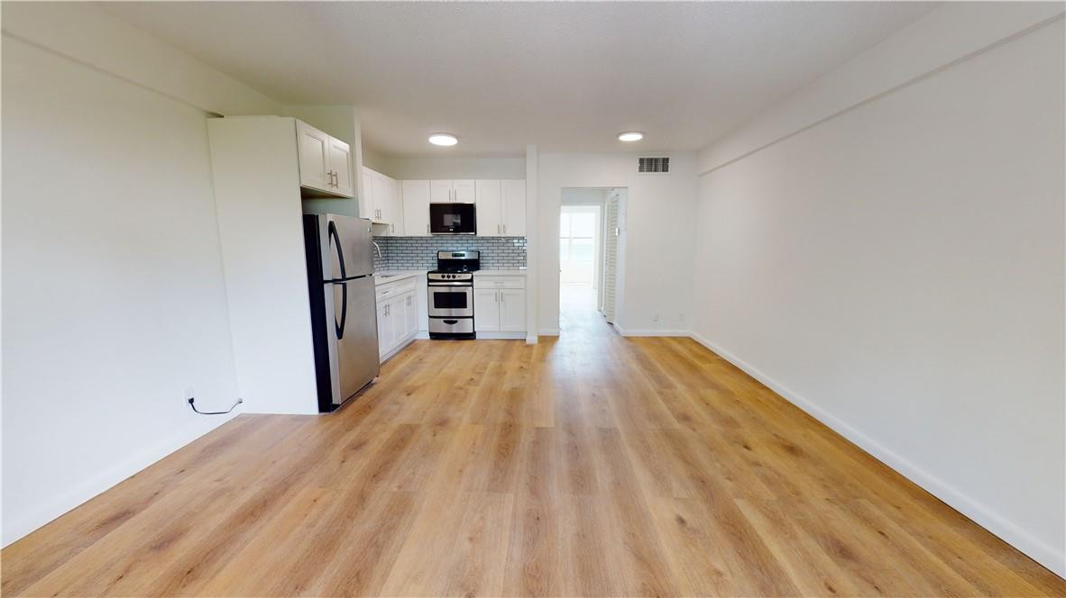 1801 South Surf Road, Unit 2F Hollywood, FL 33019 - Photo 5 of 22 a view of kitchen with stainless steel appliances wooden floor