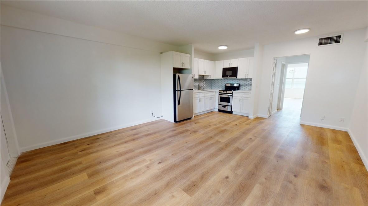 1801 South Surf Road, Unit 2F Hollywood, FL 33019 - Photo 6 of 22 a view of kitchen with wooden floor and electronic appliances