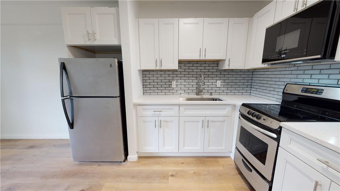 1801 South Surf Road, Unit 2F Hollywood, FL 33019 - Photo 7 of 22 a kitchen with a sink stove and microwave