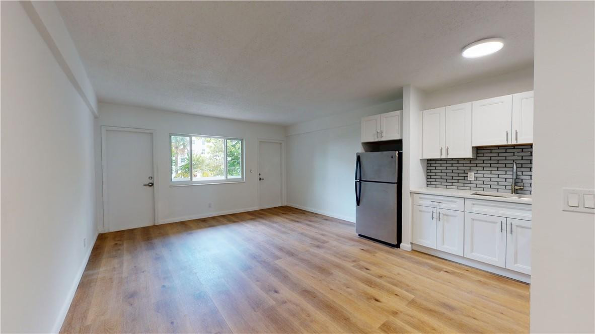 1801 South Surf Road, Unit 2F Hollywood, FL 33019 - Photo 8 of 22 a kitchen with a refrigerator and window
