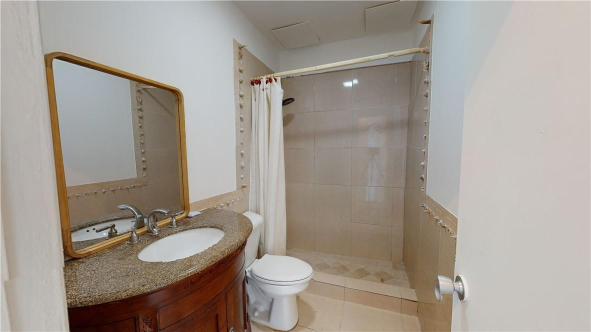 1801 South Surf Road, Unit 2F Hollywood, FL 33019 - Photo 9 of 22 a bathroom with a granite countertop sink toilet and shower
