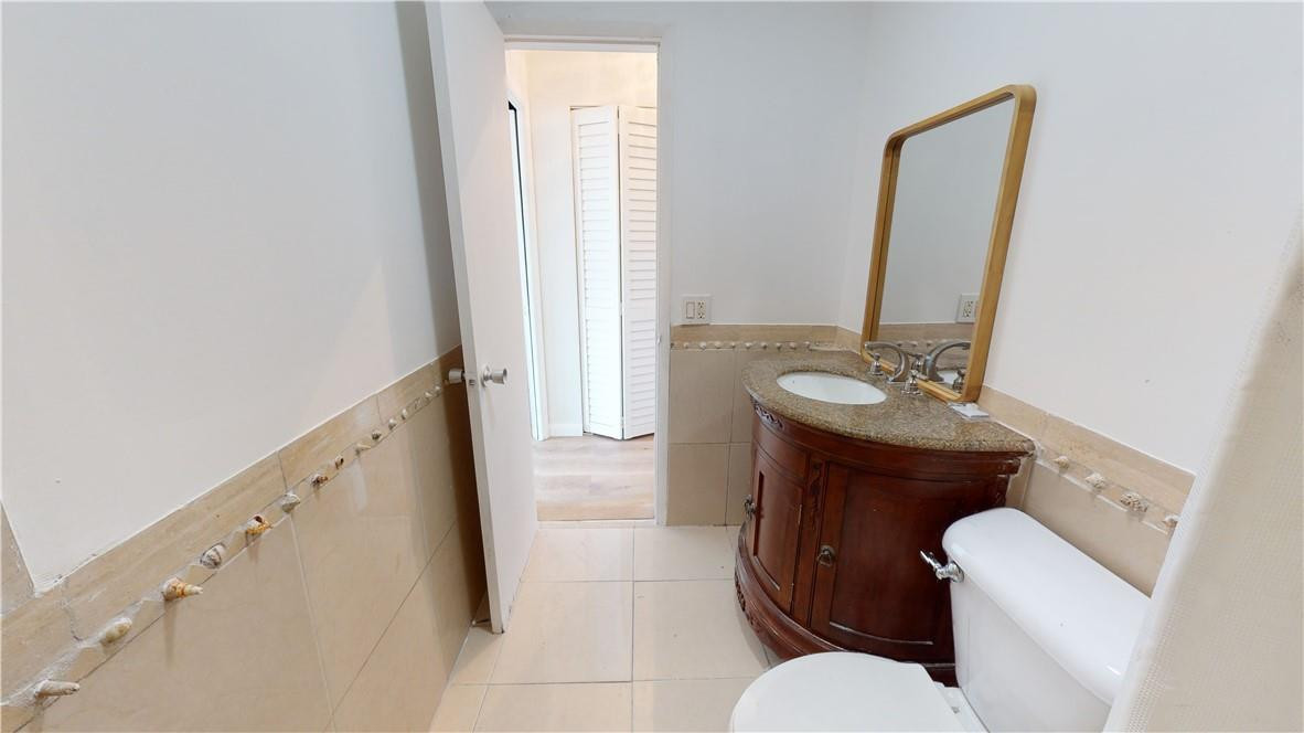 1801 South Surf Road, Unit 2F Hollywood, FL 33019 - Photo 10 of 22 a bathroom with a sink toilet and mirror