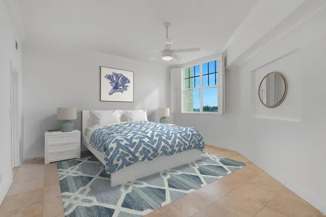 a bedroom with a bed and painting on the wall