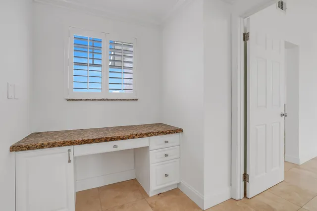a utility room with granite countertop cabinets washer and dryer