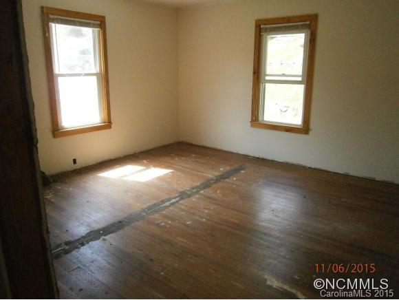 600 Wilson Branch Road Canton, NC 28716 - Photo 14 of 24 an empty room with wooden floor and windows