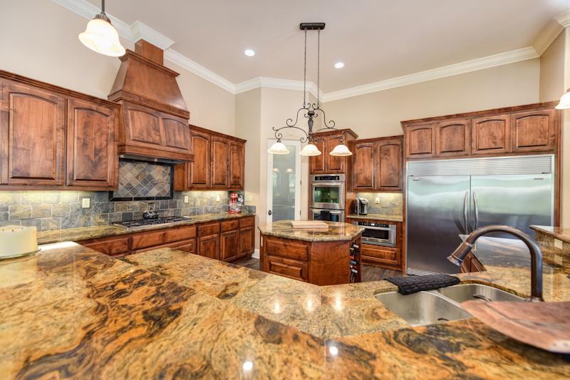 3164 Humphrey Road Loomis, CA 95650 - Photo 17 of 33 a kitchen with stainless steel appliances granite countertop a sink a stove and a refrigerator