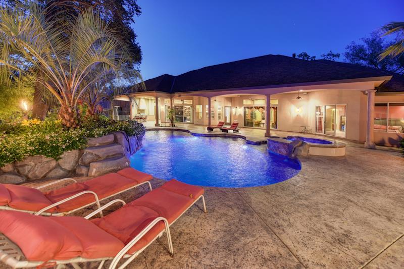 3164 Humphrey Road Loomis, CA 95650 - Photo 32 of 33 a view of a swimming pool with lawn chairs under an umbrella