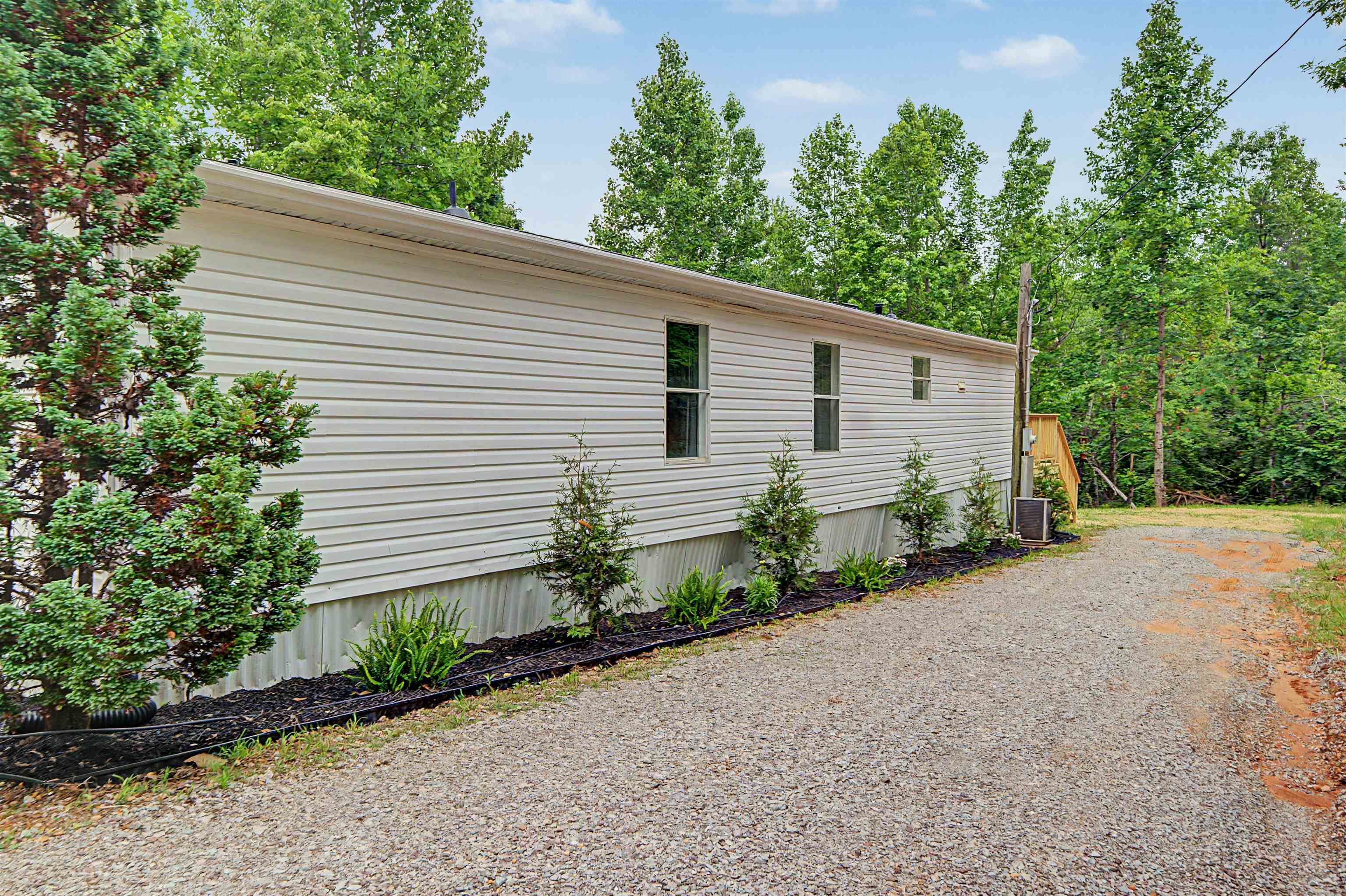 890 Burks Road Savannah, TN 38372 - Photo 28 of 40 a front view of a house with a yard and potted plants