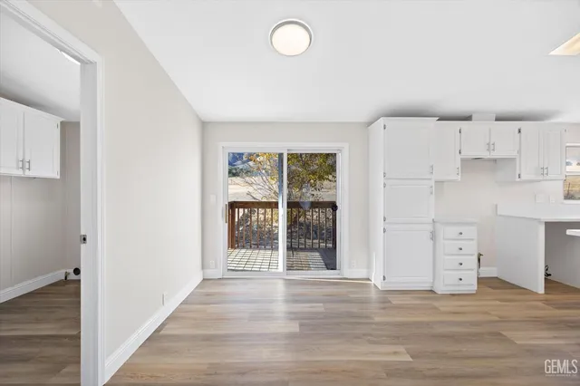 a view of a kitchen with wooden floor and window